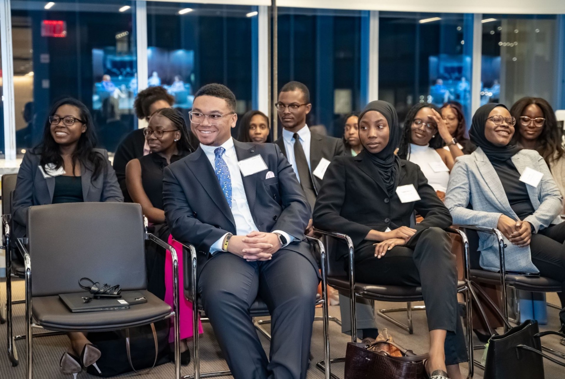 African and Caribbean law students and attorneys sitting in the audience facing a group of speakers at an event